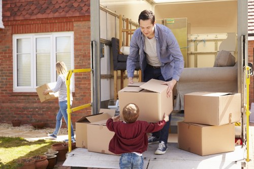Removal team handling a flat move in Enfield with boxes and furniture