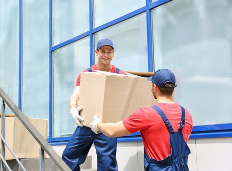 Furniture removals team handling household items in Enfield